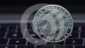 4K Physical metal silver Litecoin currency on notebook computer keyboard LTC