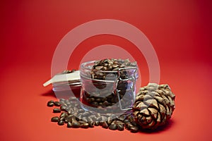 4k. Pine nuts and pine cones rotate on a red background