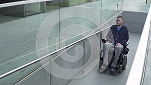 4k resolution follow of a man on electric wheelchair using a ramp. Accessibility concept