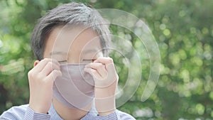 4k Selective focus young Asian boy with face mask