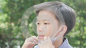 4k Selective focus young Asian boy with face mask
