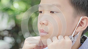 4k Selective focus young Asian boy with face mask to protect visus,