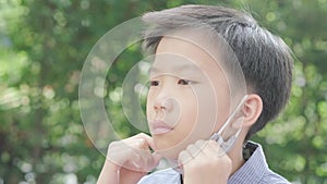 4k Selective focus young Asian boy with face mask to protect visus