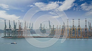 4K. Singapore shipping port with cargo ship sailing slowly on the sea and many container and yellow cranes in background