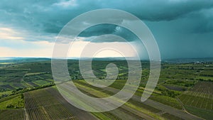 4K Slow drone flying over summer fields towards storm cloud