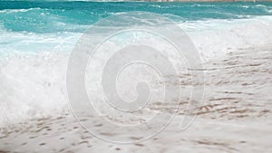 4k slow motion beautiful video of blue sea waves breaking over the shoreline. Ocean waves on the sandy beach