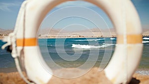 4k slow motion video of life saving ring buoy on the sandy beach at windy day on the beach