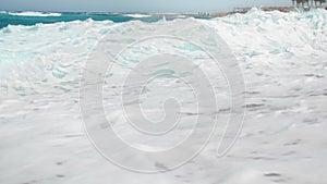 4k slow motion video of powerful turquoise sea waves breaking on shoreline at bright sunny day