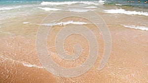 4k slow motion video of sea waves rolling on the sandy beach at bright sunnny day