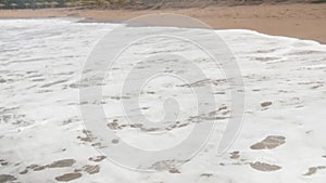 4k slow motion video of sea waves rolling on the sandy beach at bright sunnny day