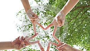 4K. successful team: five peoples raise two fingers together as a star on sky background. connection people to convey coperation