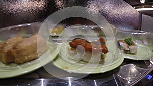 4k, Sushi on conveyor belt in Japan Restaurant, also known as sushi train