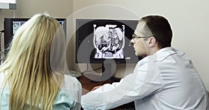 4K Three Doctors analyzing x-ray charts on the PC computer.