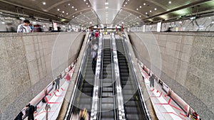 4K Time-lapse of Asian people walking and using escalator at MRT subway underground station in Singapore. Public transportation