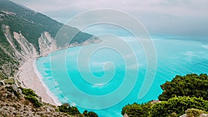 4k time lapse with flowing clouds above turquoise water surface of Myrtos beach, Kefalonia, Greece