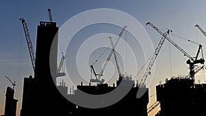 4K Time lapse of silhouette crane working in construction site