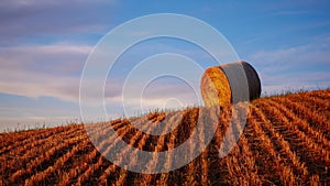 4K Timelapse of hay bales on the field at sunset, Tuscany, Italy