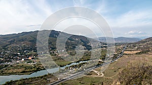 4K Timelapse of the highway with cars. Countryside city, river and mountains on the background.