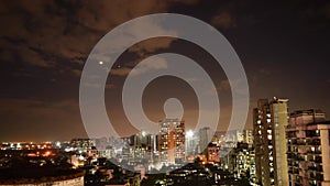 4k timelapse of Mumbai city dramatic night skyline with moving clouds cloudy sky & moon over city