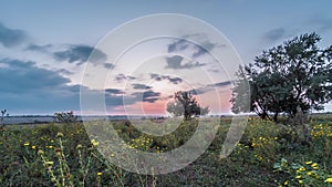 4K timelapse of sunset over the meadow. Timelapse of meadows and sunset in the early autumn