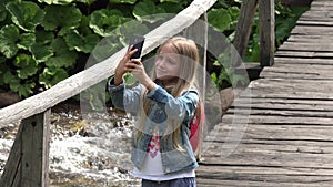 4K Tourist Girl Playing Tablet Taking Selfie, Child on Mountains Trail in Camp