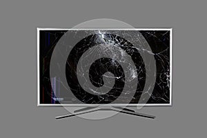 4K UHD monitor or TV with colored stripes and cracks on a broken screen isolated on grey background.