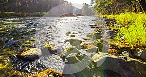 4K UHD mountain river timelapse at the summer or autumn time. Wild nature, clear water and rural evergreen valley. Sun