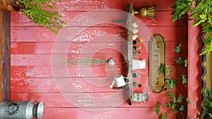 4K vertical. happy vacation concept. text happy vacay on golden vintage sign on red wooden wall plank and green leaves swaying