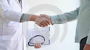 4k Video of attractive doctor and patient shaking hands for encouragement and empathy, healthcare and assistance, medical concept