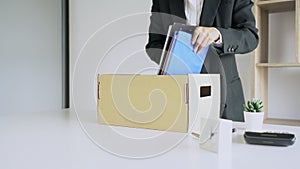 4k video of Businessmen packing up all for personal belongings and files into a brown cardboard box resignation from the company,