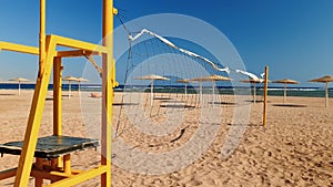 4k video of camera moving along empty sea beach with field for volleyball at bright sunny day