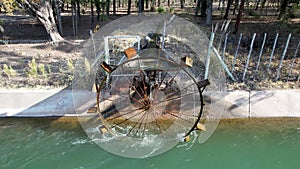 4k video of Ferris wheel drawing water from the river to irrigate