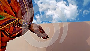 4k video Hand of a woman doing worship with betel leaf and water isolated on blue cloudy sky timelapse.