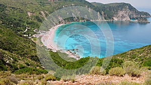 4k video of incredible beaches on Kefalonia Island. Mountains with lush greenery surrounding petani beach. clear blue