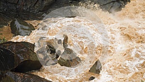 4k video of mudflow and dirty water stream flowing in the mountains while raining