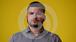 4k video of one man who responds negatively to something over yellow background.