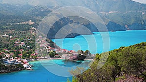 4k video. Red roofs of tranquile Assos village in mediterranean vegetation Kefalonia island Greece. Colorful houses