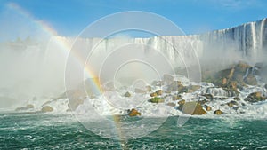 4K video: A stunning Niagara Falls and a Rainbow. Bottom view. falling water weight raises a lot of spray and mist