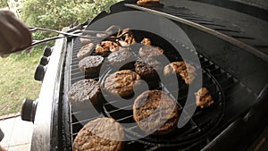 4k video of turning meat on flame grilling barbecue with fire