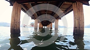 4k video under the old wwoden pier at sea