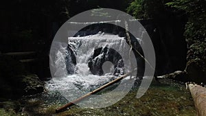 4K. View of Waterfall in Vintgar Gorge on Radovna river. Clean blue water and wooden logs. Triglav National Park, Julian Alps.