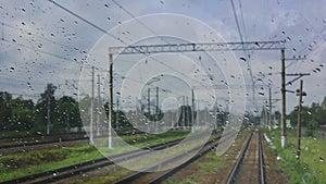 4k, view from the wet front window of a train locomotive to the railway