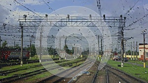 4k, view from the wet front window of a train locomotive to the railway