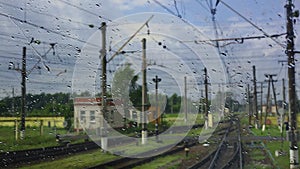 4k, view from the wet front window of a train locomotive to the railway