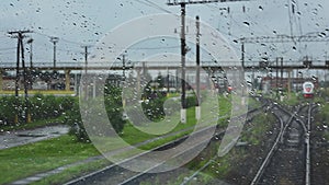 4k, view from the wet front window of a train locomotive to the railway
