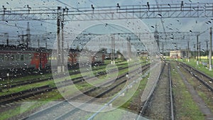 4k, view from the wet front window of a train locomotive to the railway