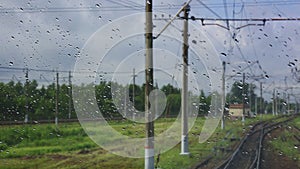 4k, view from the wet front window of a train locomotive to the railway