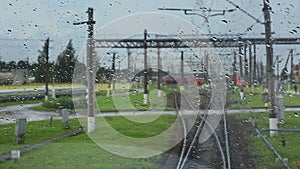 4k, view from the wet front window of a train locomotive to the railway