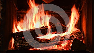 4K Warm cozy burning fire in a brick fireplace, close-up shot