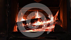 4K Warm cozy burning fire in a brick fireplace, close-up shot